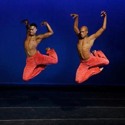 Two Men In Red Pants Are Dancing On Stage