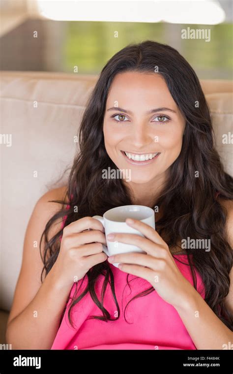 Pretty Brunette Relaxing On The Couch Stock Photo Alamy