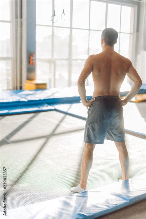 Sporty Naked To The Waste Man With Hands On The Hips Before The Workout Back View Full Length