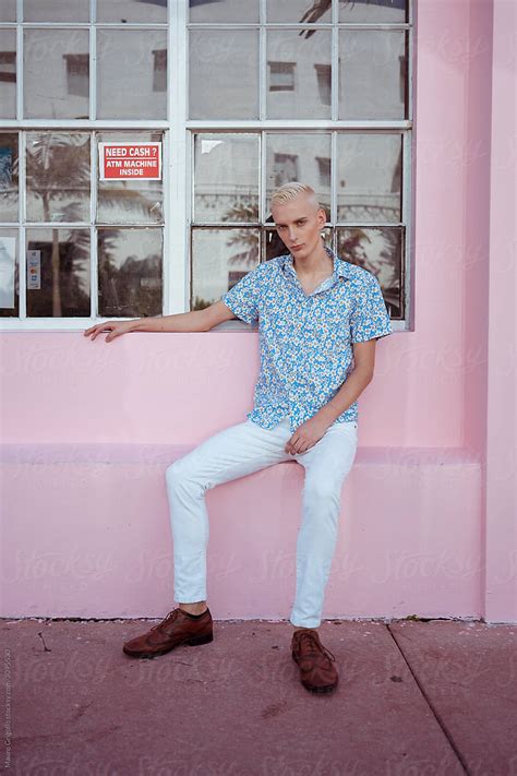 Blond Gay Man Sitting On A Pink Bench By Stocksy Contributor Mauro Grigollo Stocksy