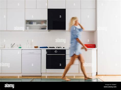 Woman Walking In Modern Kitchen Stock Photo Alamy