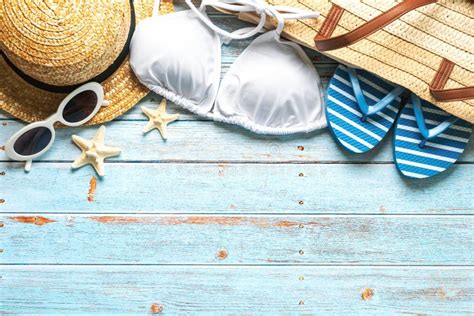 Top View Of Beach Bag Straw Hat Sunglasses Flip Flops And Bikini With Copy Space For Text