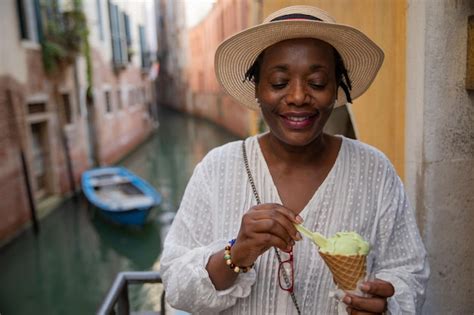 Premium Photo Aa Lady Eats Ice Cream While On Vacation In Venice Italy Mature Tourist Woman