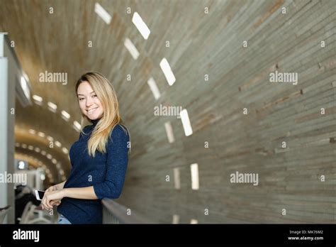 Blonde Caucasian Student Keeping Smartphone In Monophonic Background Stock Photo Alamy