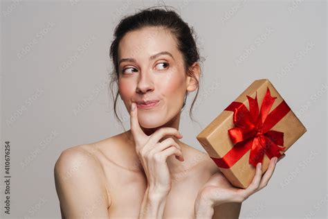 Pleased Half Naked Woman Thinking While Showing Gift Box Stock Photo Adobe Stock