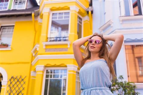 Premium Photo Portrait Attractive Blonde Model Wearing Sunglasses Behind Yellow And Blue