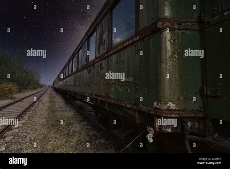 The Old Dark Green Train Car Against The Background Of Starry Sky Stock
