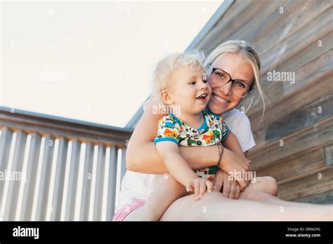 Little Boy Sitting On His Mothers Lap Stock Photo Alamy