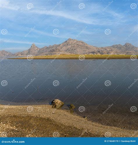 View of Pristine Landscape of Jawai Dam with Hills and Clouds Stock