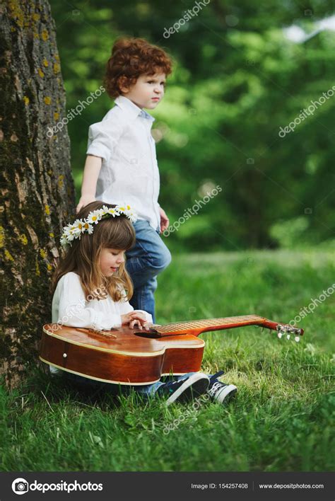 Cute little children playing guitar Stock Photo by ©ababaka 154257408