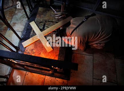 A Christian Pilgrim Kneels In Prayer Over The Stone Of The Anointing Or