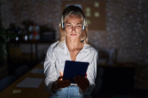 Young Blonde Woman Working At The Office At Night Depressed And Worry