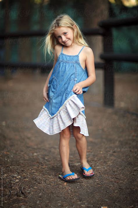 Blonde Girl Holding Edge Of Her Denim Dress By Stocksy Contributor