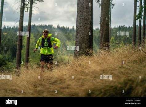 A Young Athlete In Barefoot Shoes Runs Down The Mountain Mountain Run