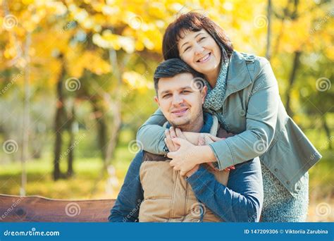Loving Happy Mature Mother Hugging Adult Son In Beautiful Sunny Park Mother Day Lifestyle