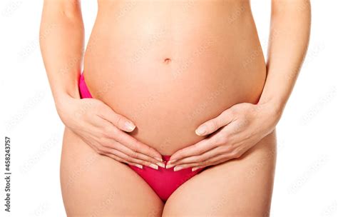 Sexy Pregnant Woman In Lingerie Holding Her Belly Isolated On White Background Stock Photo