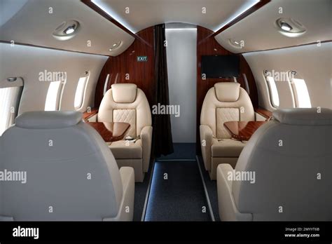 airplane cabin  comfortable seats  tables stock photo alamy