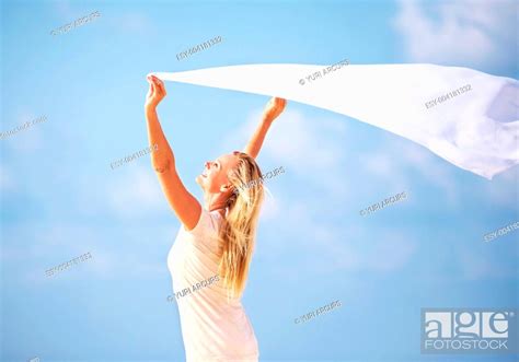 Portrait Of Carefree Mature Woman With Sarong Against Blue Sky Stock