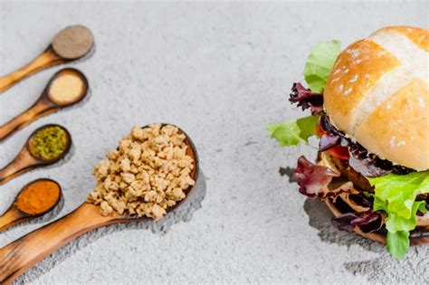 Premium Photo Soya Vegan Burger On Wooden Surface With Vegetables