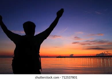 Silhouette Man Hands Raised Beautiful Sunrise Stock Photo