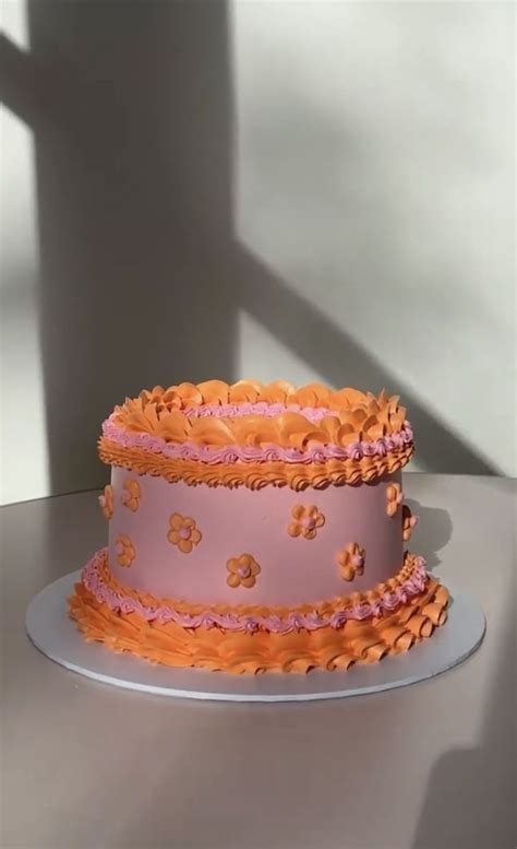 A Pink And Orange Cake Sitting On Top Of A Table