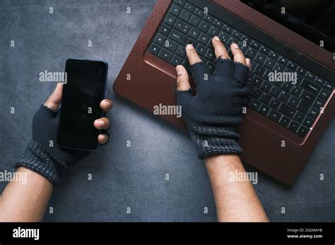 Hacker Hand Stealing Data From Laptop Top Down Stock Photo Alamy