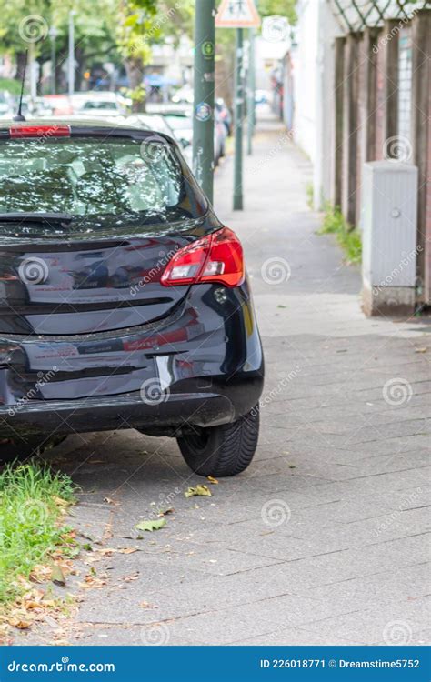 Badly Parked Car With Tire On Pavement Shows Wheel On Walkway As