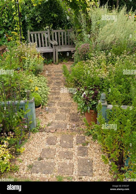 Small English cottage garden with paved and gravel path, borders and ...