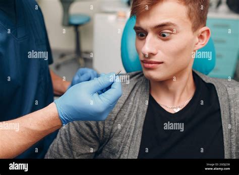 Dentistry Dentist Shows Implant To Patient Of Dental Clinic Stock