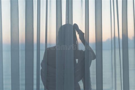 Naked Beautiful Girl Stands Behind The Transparent Curtain Combing Her Hair On The Balcony Early