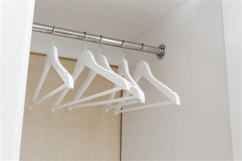 Premium Photo | White empty wardrobe closet with hangers wooden white ...