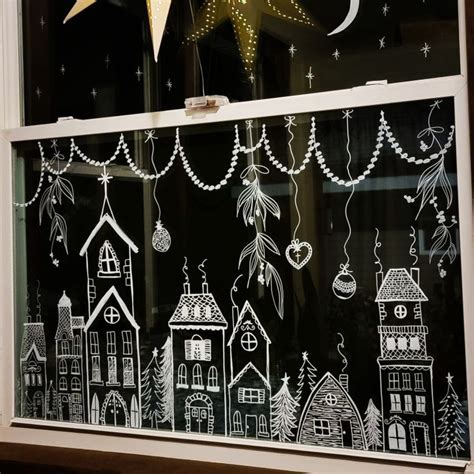 A Window With Christmas Decorations Drawn On It In Front Of A Star