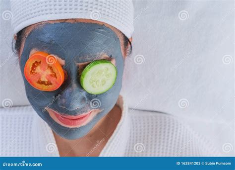 Beautiful Woman With A Face Mask With Cucumbers And Tomatoes On The Eye