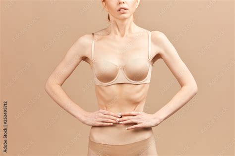 Unrecognizable Skinny Anorexic Woman Posing In Nude Underwear Measuring Her Waist With Tape