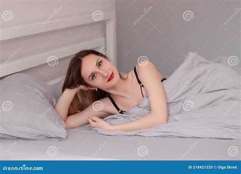 Pretty Redhead Woman In Black Lace Lingerie On Bed With Grey Sheets Stock Photo Image Of