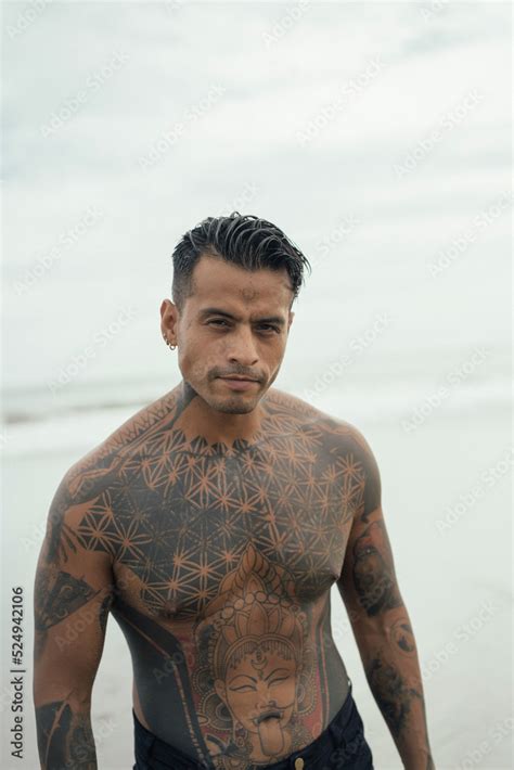 Handsome Tanned Tattooed Sexy Man With A Naked Torso In A Flying Poreo