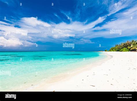 White sandy beach in Maldives with amazing blue lagoon and blue sky ...