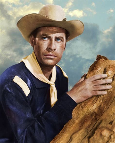 A Man In A Cowboy Hat Leaning On A Tree Trunk With His Hand On The Log