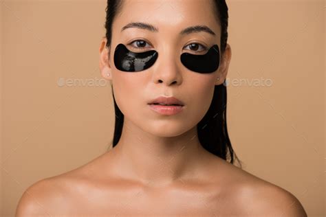Beautiful Naked Asian Girl With Black Hydrogel Eye Patches Under Eyes Isolated On Beige Stock