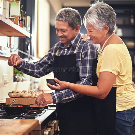 Seasoned With Love Shot Of A Mature Couple Cooking Together At Home