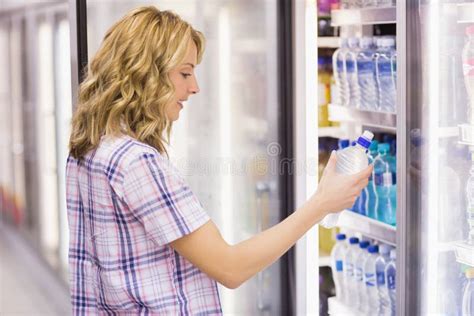 Smiling Blonde Woman Taking A Water Bottle Stock Photo Image Of Supermarket Market
