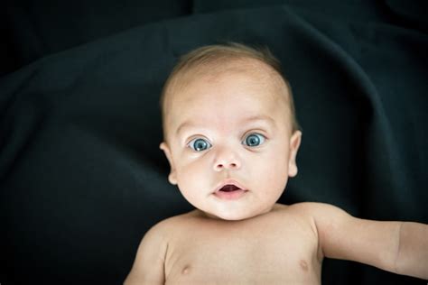 Premium Photo Blue Eyed Naked Baby Lying On Black Fabric