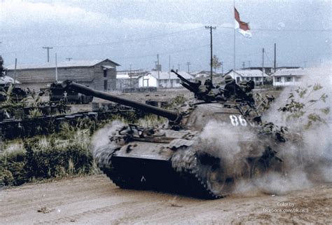 A T-54 of the Vietnam People Army speeding through a South Vietnamese base during the 1975 ...