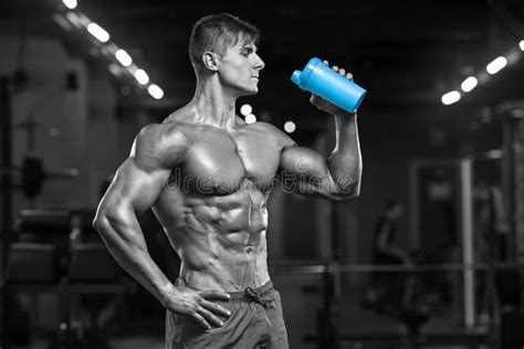 Muscular Man Drinking Water In Gym Shaped Abdominal Strong Male Naked Torso Abs Working Out