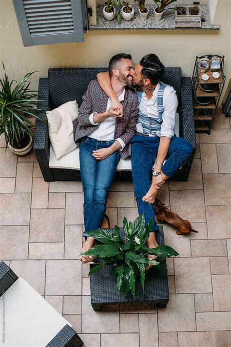 A Gay Couple Kissing On The Couch View From Above By Stocksy Contributor Michela Ravasio