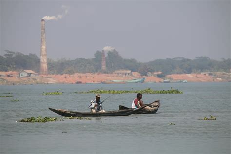 Fishermen Paddling a BoatFree Stock Photo