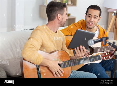 Musician Teaching His Friend Playing Guitar Stock Photo Alamy