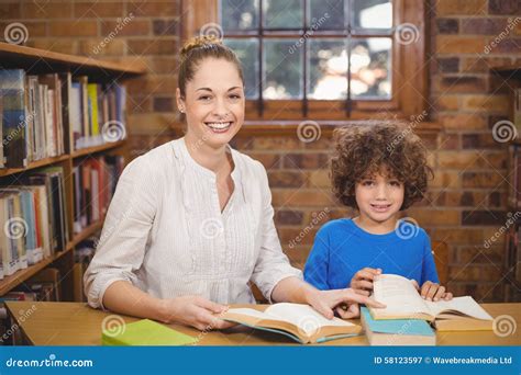 Blonde Teacher And Pupil Reading Books In The Library Stock Image Image Of Academic Portrait