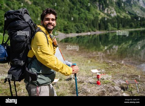 Handsome Happy Backpacker Man Hiking Camping Through Mountain Forest