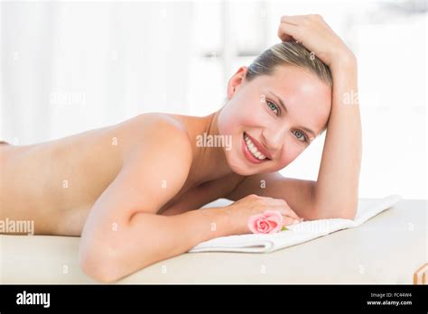 Peaceful Blonde Lying On Towel Smiling At Camera Stock Photo Alamy